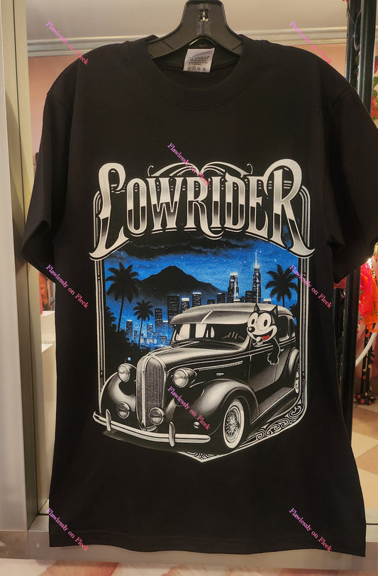 Stylish Lowrider Felix the Cat Graphic T-Shirt featuring a classic car and vibrant city skyline design.